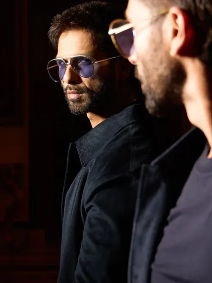A cool, reflective shot of Shahid. The sunglasses and the moody lighting give this a very cinematic feel.