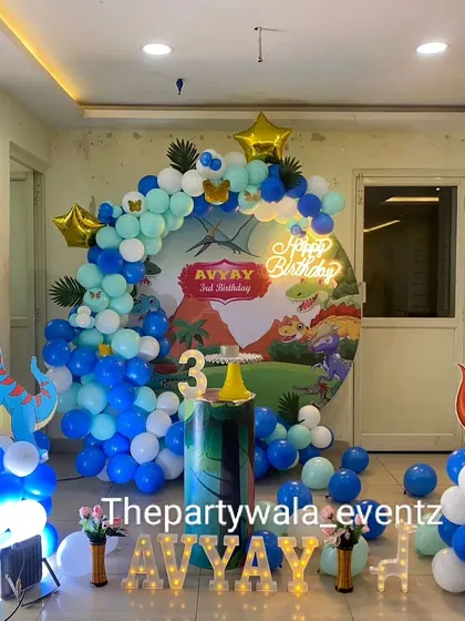 A fun dinosaur theme with a blue and green color scheme, perfect for a 3rd birthday party.