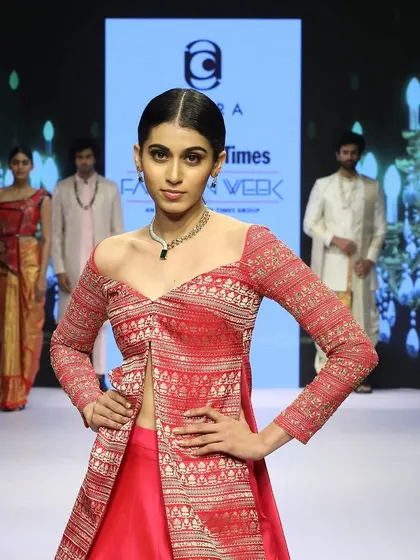 A close-up of the Pink Banaras koti, showcasing the off-shoulder neckline and the intricate weave of the fabric. It’s a perfect example of how I deconstruct and reconstruct traditional pieces to create something new.