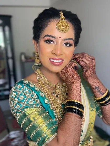A beautiful, happy bride. I created a soft glam look with glowing skin and defined eyes to complement her green and cream silk saree and traditional gold jewellery.