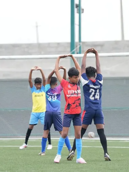 Players performing stretching exercises during the final trials in Bangalore. Proper warm-ups are essential for peak performance.