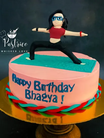 A fitness-themed cake for a yoga lover, featuring a handcrafted figurine in a warrior pose on a yoga mat.