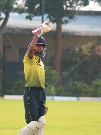 A batter acknowledges applause from teammates, a moment of personal achievement on the field.