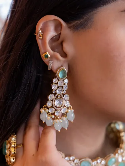 Another beautiful close-up of our mint green and Kundan bridal earrings. This image highlights the craftsmanship and the delicate arrangement of stones and beads.