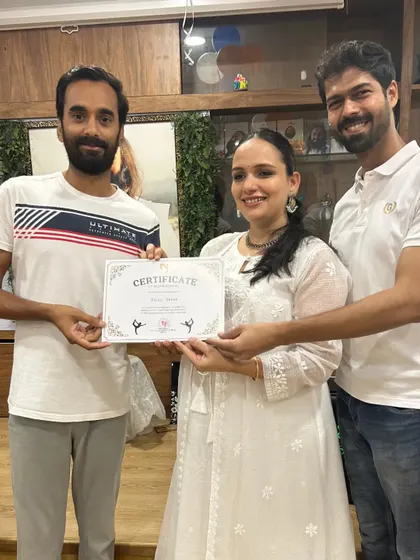 A student from the runner-up team receives his certificate. The smiles and handshakes show the mutual respect and friendship in our community.