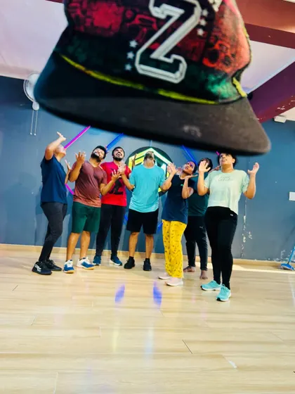 Get fit, have fun, and join the party. This creative group photo captures the playful and energetic spirit of our Zumbamania community.