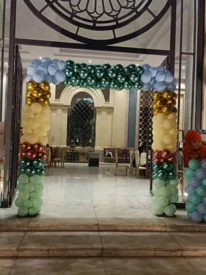 A beautiful balloon arch gate at the entrance of a banquet hall. This is a great way to welcome guests and set the theme for the party right from the start.