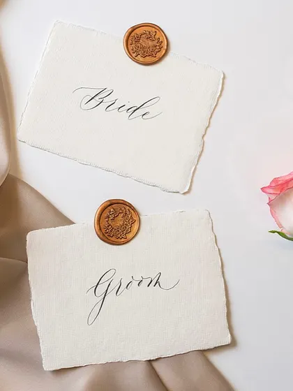 I wish people opted for this modern calligraphy script more often. Its elegance is understated yet strikingly beautiful. Here it is on simple 'Bride' and 'Groom' place cards.