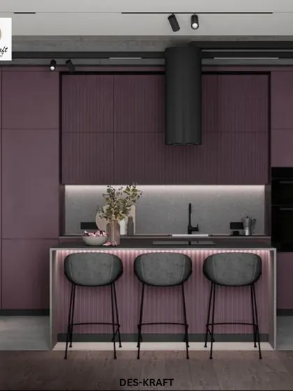 A bold and moody kitchen design featuring deep plum-colored cabinetry with a ribbed texture. The illuminated island and sleek black stools create a dramatic, high-end look.