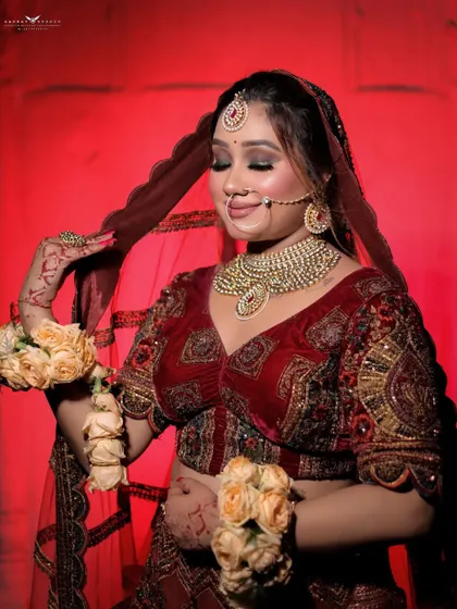 A soft and serene portrait of the bride with her eyes closed. The focus is on her calm expression and the beautiful details of her red velvet blouse and sheer dupatta.