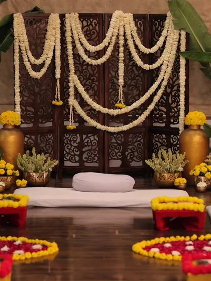 The complete setup for an intimate, at-home mehendi ceremony. We used floor seating, banana leaves, jasmine and marigold flowers, and brass props to create a warm, traditional South Indian vibe.