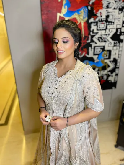 The soft smokey eye and glowing skin create a look of pure elegance.
