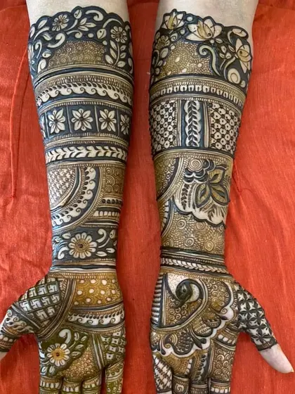 A beautiful combination of floral bands and peacock motifs on the palms, with a different intricate pattern on each arm.