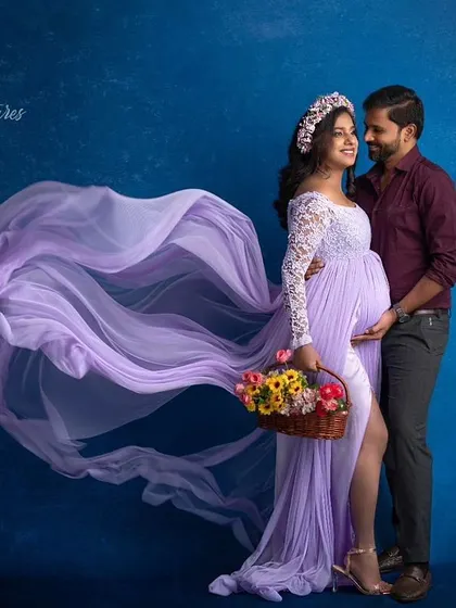 A romantic couple's maternity shoot. The makeup is soft and pretty, complementing the lavender gown and creating a beautiful, harmonious portrait.