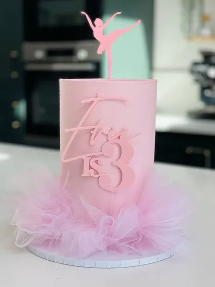 A ballerina-themed pink dreamy cake with a tulle tutu.