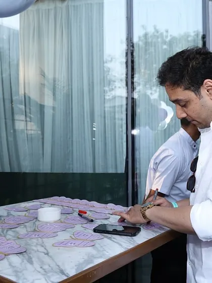 Guests writing their wishes on custom butterfly-shaped cards.