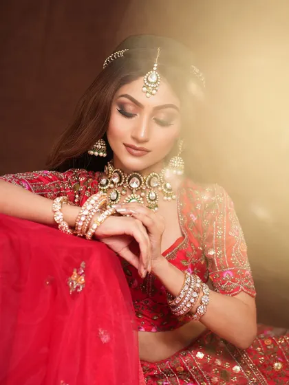 A beautiful portrait from the photoshoot, the soft lighting creating a dreamy effect on her glamorous makeup.