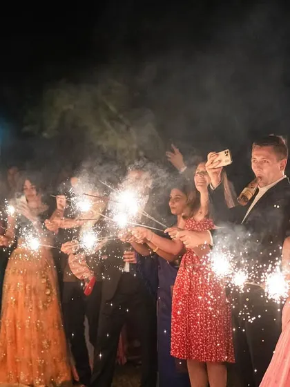 Guests light up the night with sparklers to celebrate the couple, adding a touch of magic and creating a beautiful photo opportunity.