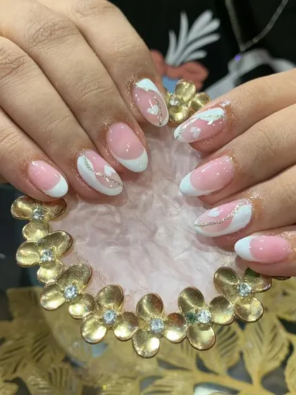 A soft and dreamy design with pink and white abstract shapes, clouds, and a delicate silver glitter line.