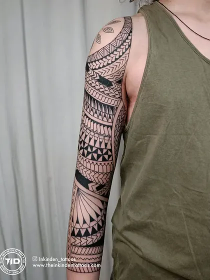 The side view of a completed Maori sleeve, displaying the seamless wrap-around design. The balance between dense blackwork and detailed patterns is key to creating a visually striking and authentic piece.