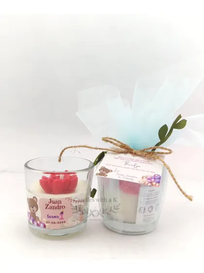A first birthday return gift set featuring a peony flower votive candle, personalized with a teddy bear theme.