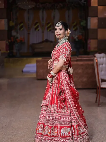 A side profile of the bride, showing off the elegant bun and the way the dupatta is set.