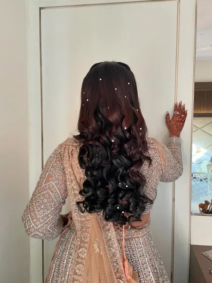 A closer look at the pearl-adorned hairstyle, which catches the light beautifully as she moves.