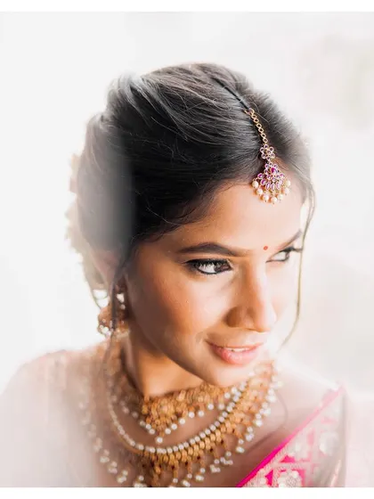 Flawless minimal skin work for Sneha, captured in beautiful sunlight. This bright, airy shot highlights the natural, dewy finish of her makeup.
