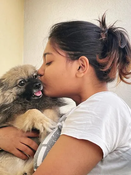 Giving our own baby, Perri, a kiss. This is the love and affection we share with every single dog that comes through our door. They are all family here.