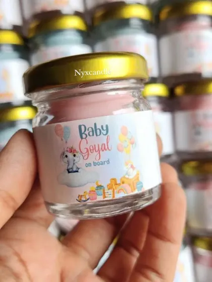 A close-up of the "Baby Goyal on board" candle, a sweet and personal way to share exciting news.