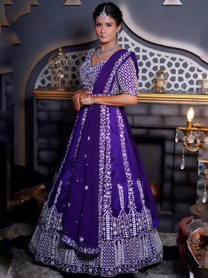 A full-length shot of the purple and white embroidered lehenga in a regal setting. This outfit is perfect for creating dramatic and beautiful photos.