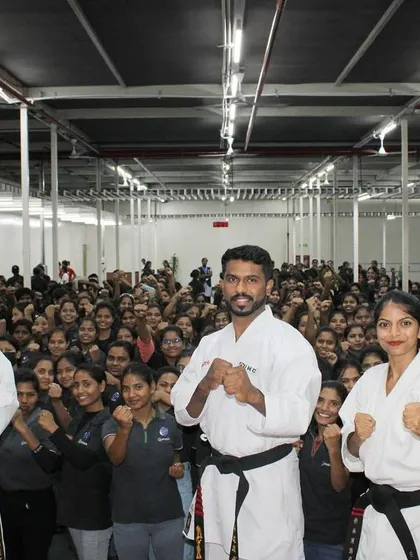 A close-up of our instructors and the front-row participants at the Ather corporate workshop, showcasing the large scale of the event.