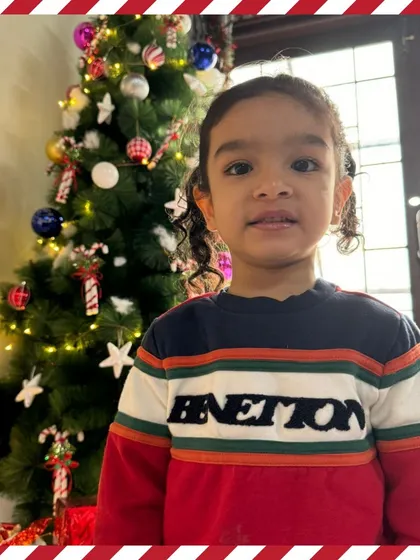 A sweet portrait in front of the Christmas tree.