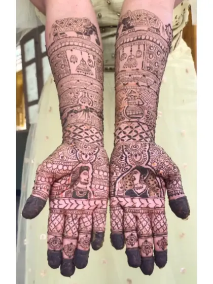 A beautiful example of Raja-Rani (King and Queen) style portraits for a bride. The design is filled with traditional elements like elephants and hanging jhumkas.