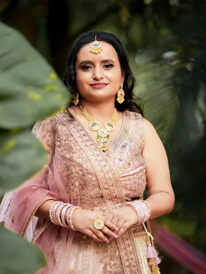 A close-up portrait of the bride, focusing on her beautiful jewelry and gentle smile.