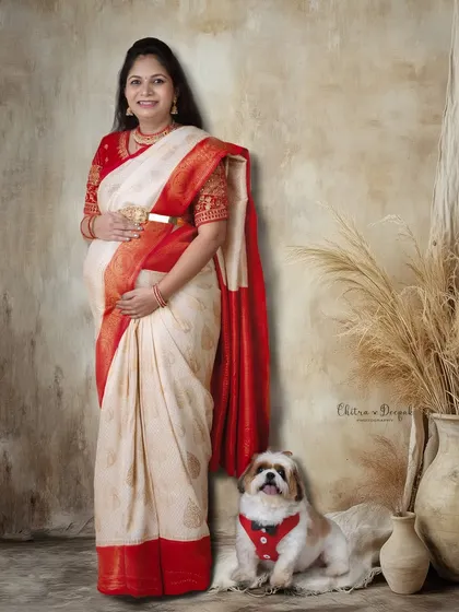 A traditional portrait with a furry friend! This mom-to-be in her beautiful saree is joined by her adorable pet for a complete family photo.
