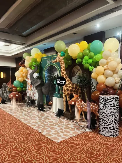 Another angle of a jungle safari setup, with a tall giraffe, an elephant, and a gorilla creating a fun and wild atmosphere.