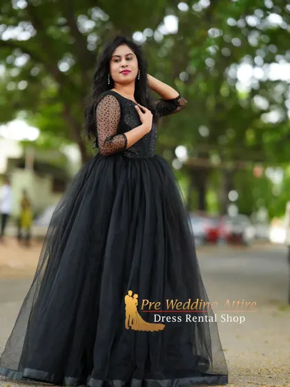 A portrait in the black ball gown, highlighting the sheer dotted sleeves and neckline.