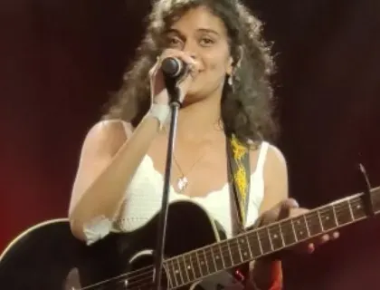 A happy smile for the crowd. Connecting with people through my music is the best part of being a live singer.