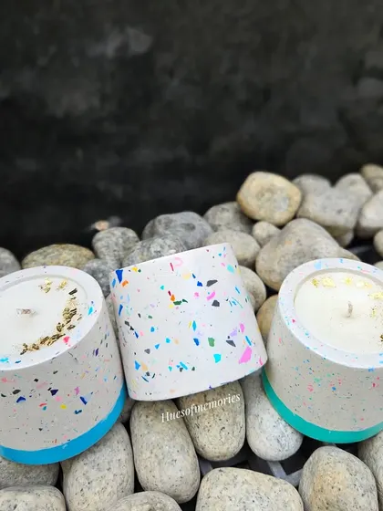 Three of my terrazzo-style cylinder candles. The colorful terrazzo chips are mixed into the eco-resin, making each jar completely unique. The soy wax is topped with gold foil for a luxurious finish.
