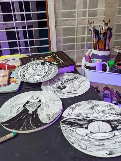 Some of my ink illustrations inspired by mythology, laid out on my desk. I enjoy the challenge of detailed line work and creating narrative scenes.