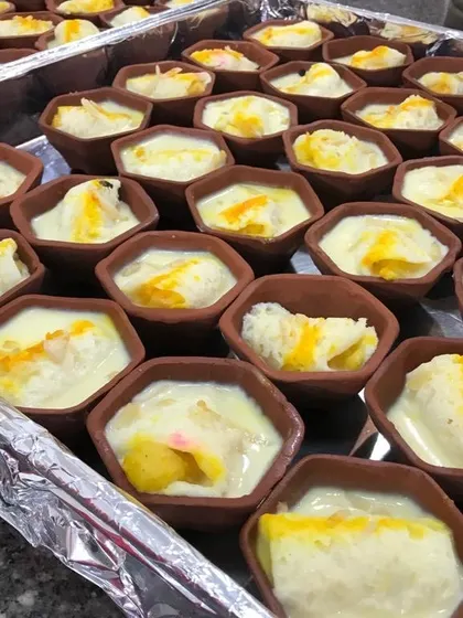 I offer several varieties of sweets served in earthen pots (matkas). This tray shows another popular option, a creamy dessert with a sweet yellow topping, ready to be served at a celebration.