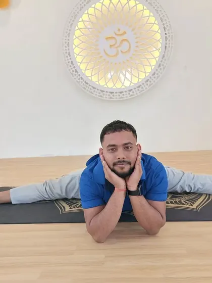 A student relaxes into a full split, Upavistha Konasana, showcasing the results of consistent practice.