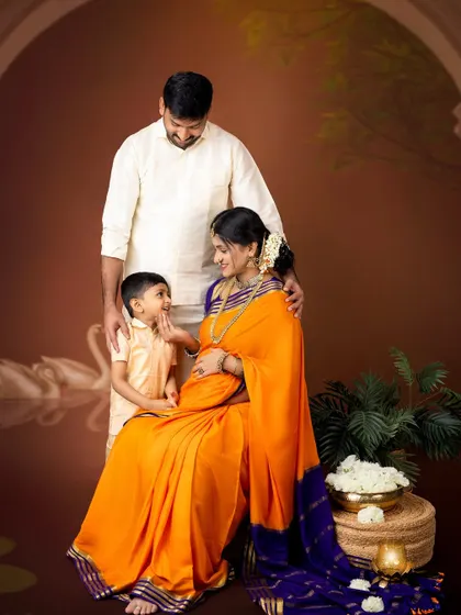 A beautiful family moment during a traditional maternity shoot. The older brother-to-be sweetly interacts with the baby bump, creating a touching family portrait.