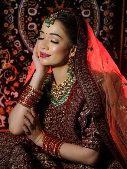 A dramatic shot with red lighting, showing how well the makeup holds up under different lighting conditions. The highlight on the cheekbones catches the light beautifully.