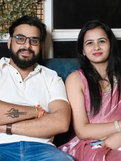A relaxed portrait of a couple seated on a couch, captured in a casual setting.
