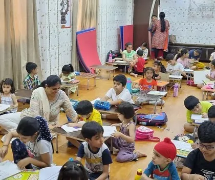 Another view of our bustling classroom. We use a mix of floor seating and low tables to create a comfortable and flexible learning space.