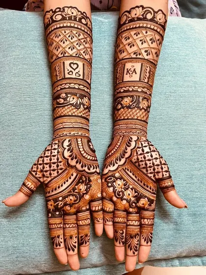 A classic engagement design with the couple's initials, 'K' and 'A', and a heart symbol. The geometric patterns and floral borders give it a modern yet traditional feel.