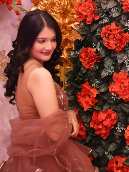 A side profile showing her elegant hairstyle and the soft glow of her makeup.