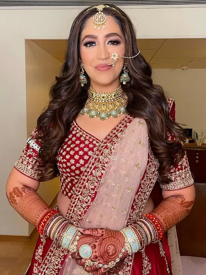 A full view of the bride's happy face, her hair styled in soft, open curls that perfectly match her joyful vibe.
